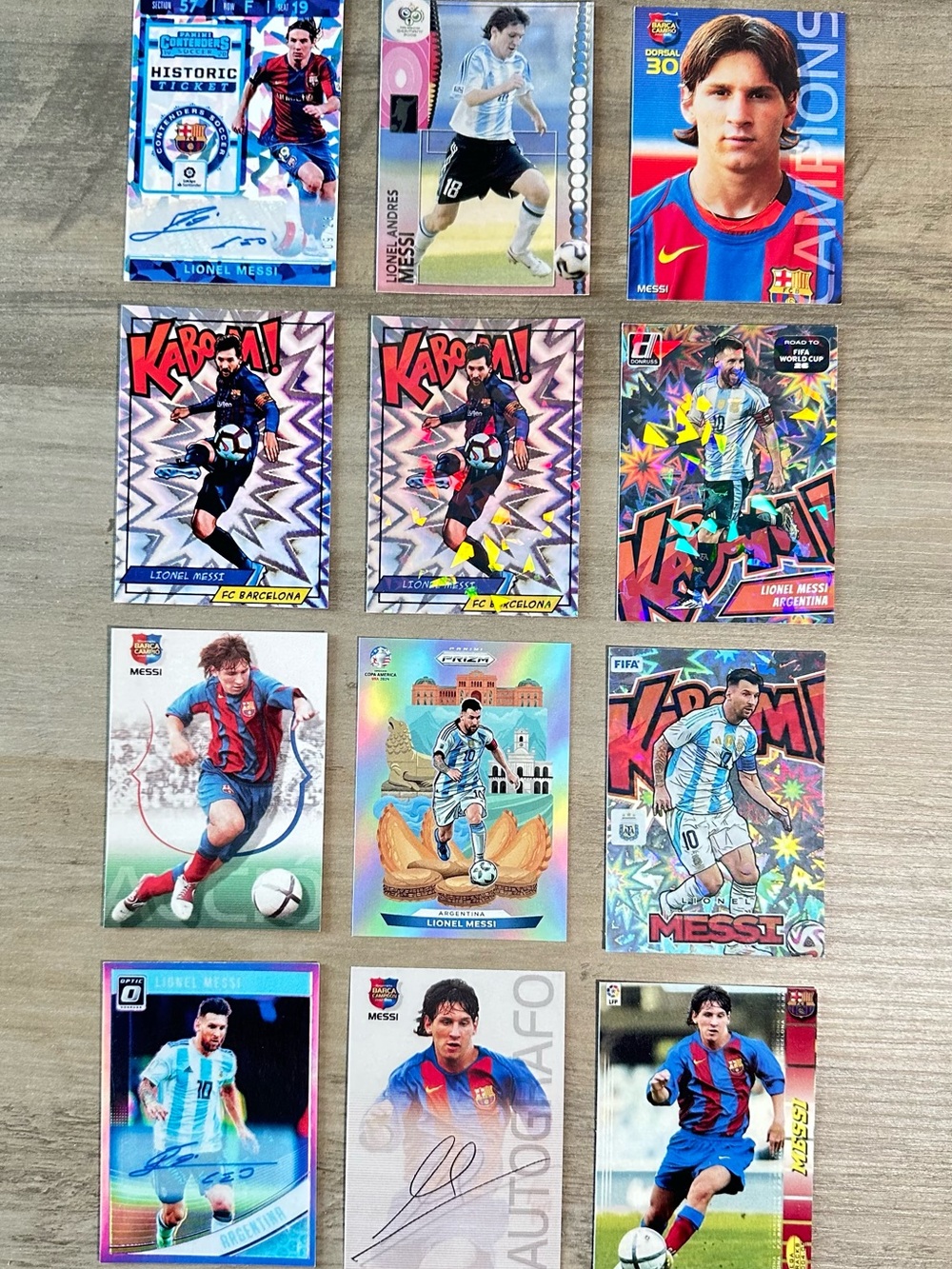 Lionel Messi Signed Rookie Lot of (12) Panini Kaboom Prizm Novelty Cards.